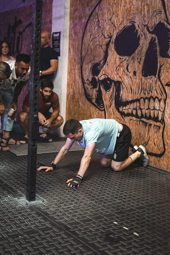 Athlete on the CrossFit Puerto Banús floor beside the skull wall