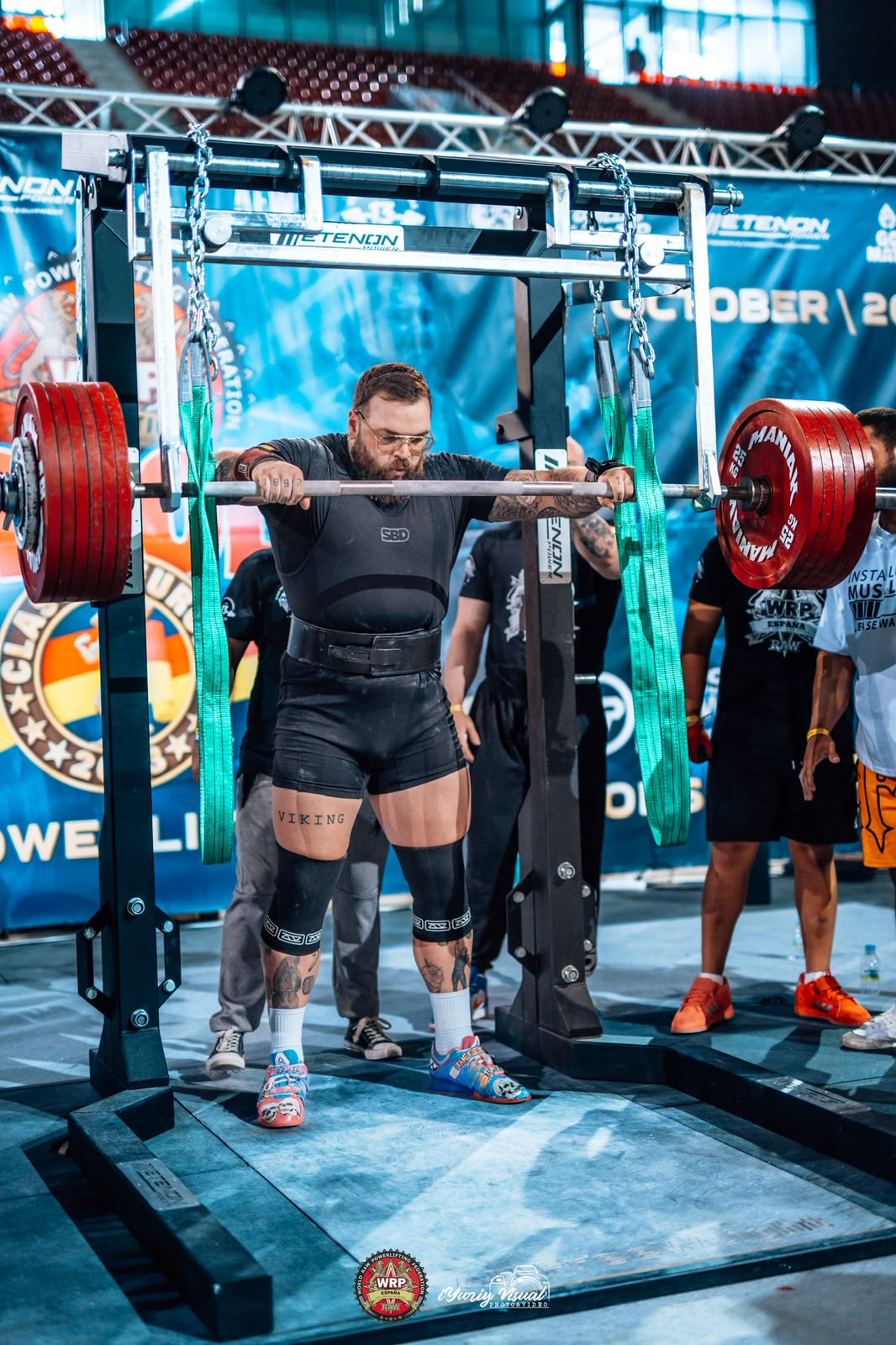 Powerlifter preparing under a heavily loaded squat bar
